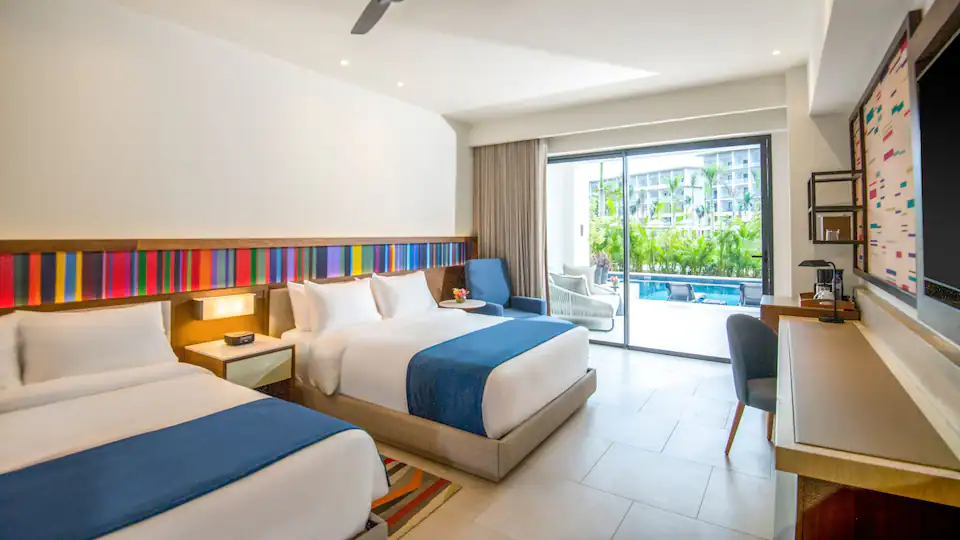 Club Junior Suite Swim-Up Double guest room with two queen beds at Hyatt Zilara Cap Cana.