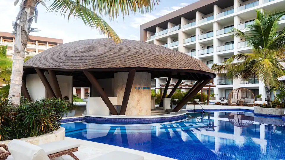 Cocoonz poolside bar at Hyatt Zilara Cap Cana featuring shaded lounge seating, tropical cocktails, and a relaxed resort atmosphere.