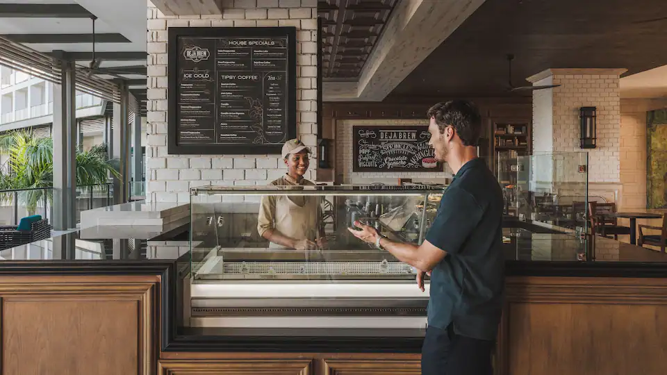 Deja Brew coffee shop at Hyatt Zilara Cap Cana featuring specialty coffee drinks, fresh pastries, and a cozy contemporary café atmosphere.