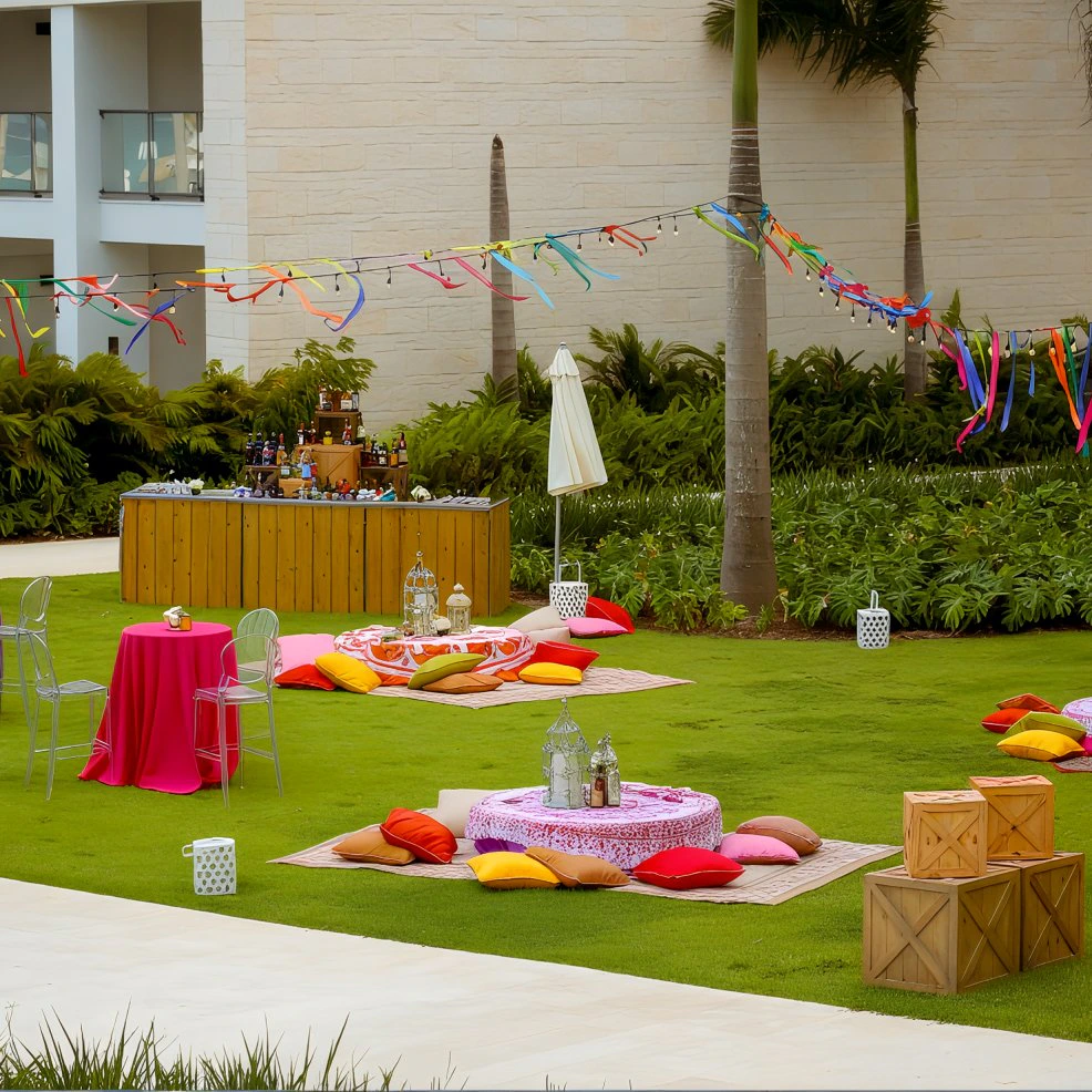 Outdoor lawn event setup with colorful décor and lounge seating at Hyatt Zilara Cap Cana.