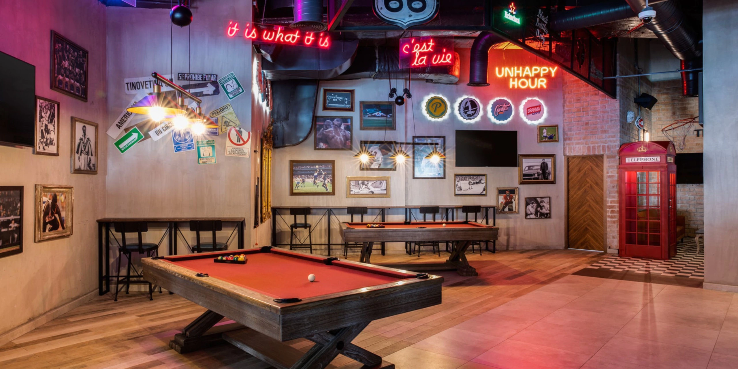 Entertainment lounge with pool tables, neon signs, and social gaming spaces at Hyatt Zilara Cap Cana.