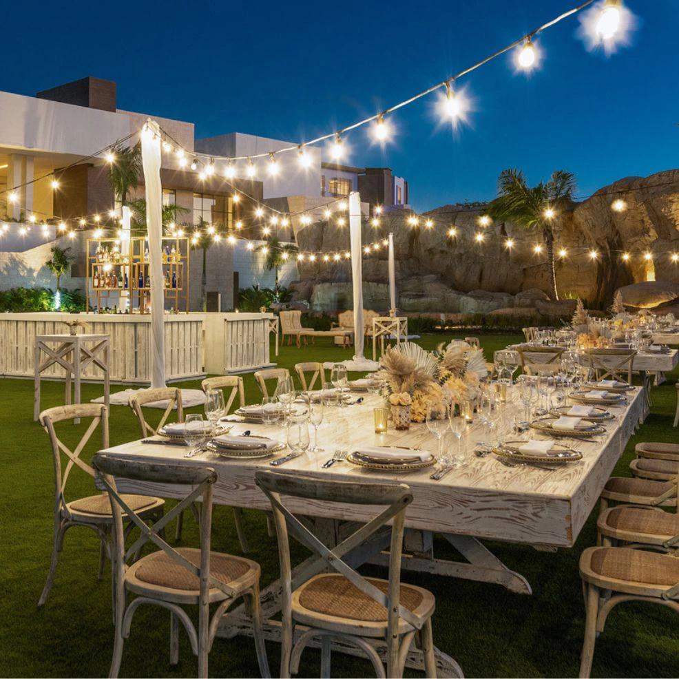 Elegant outdoor dinner reception with string lights at Larimar Lawn at Hyatt Zilara Cap Cana.