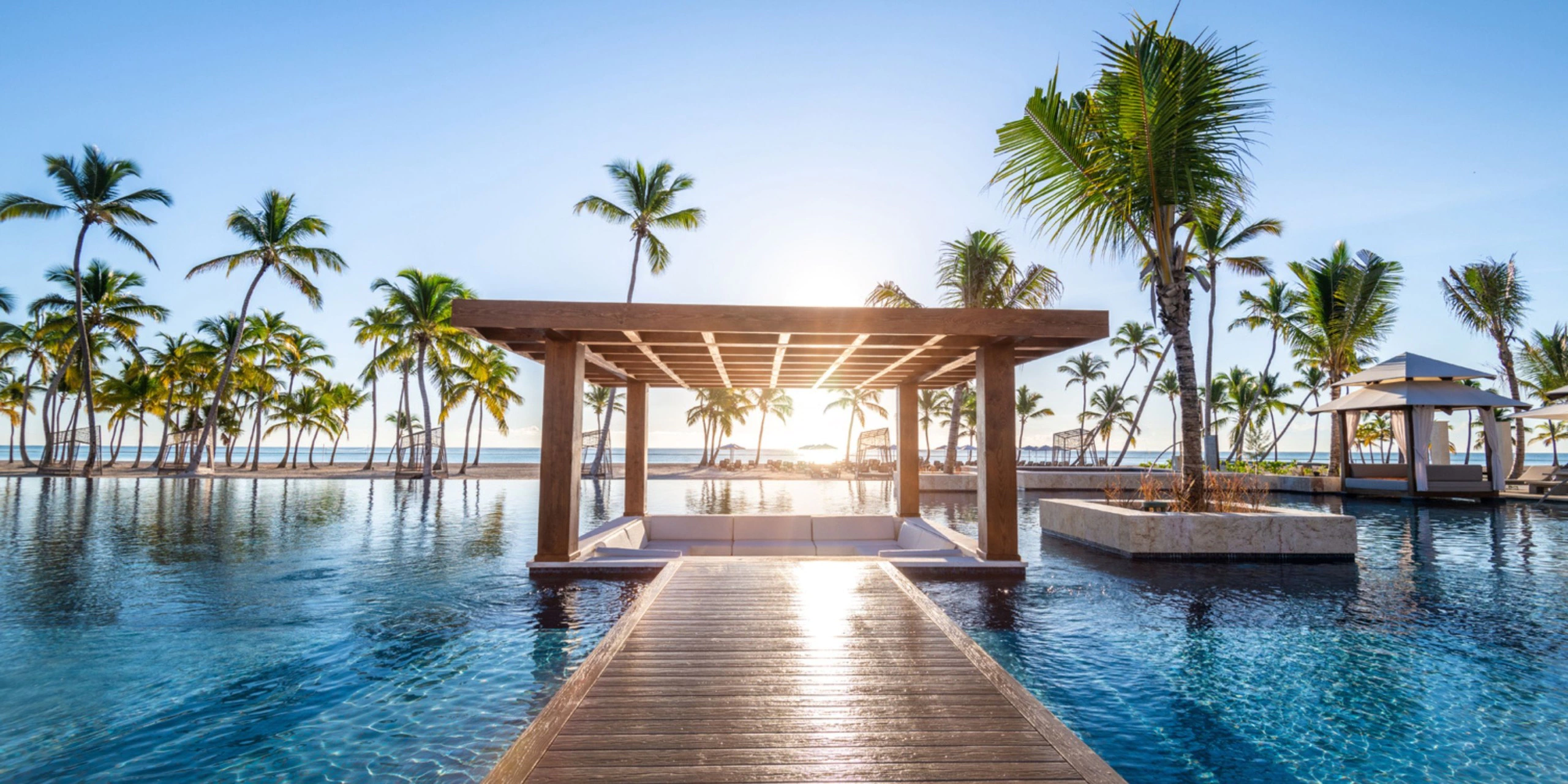 Elegant pool pavilion surrounded by tropical palms and crystal-clear water at Hyatt Zilara Cap Cana.