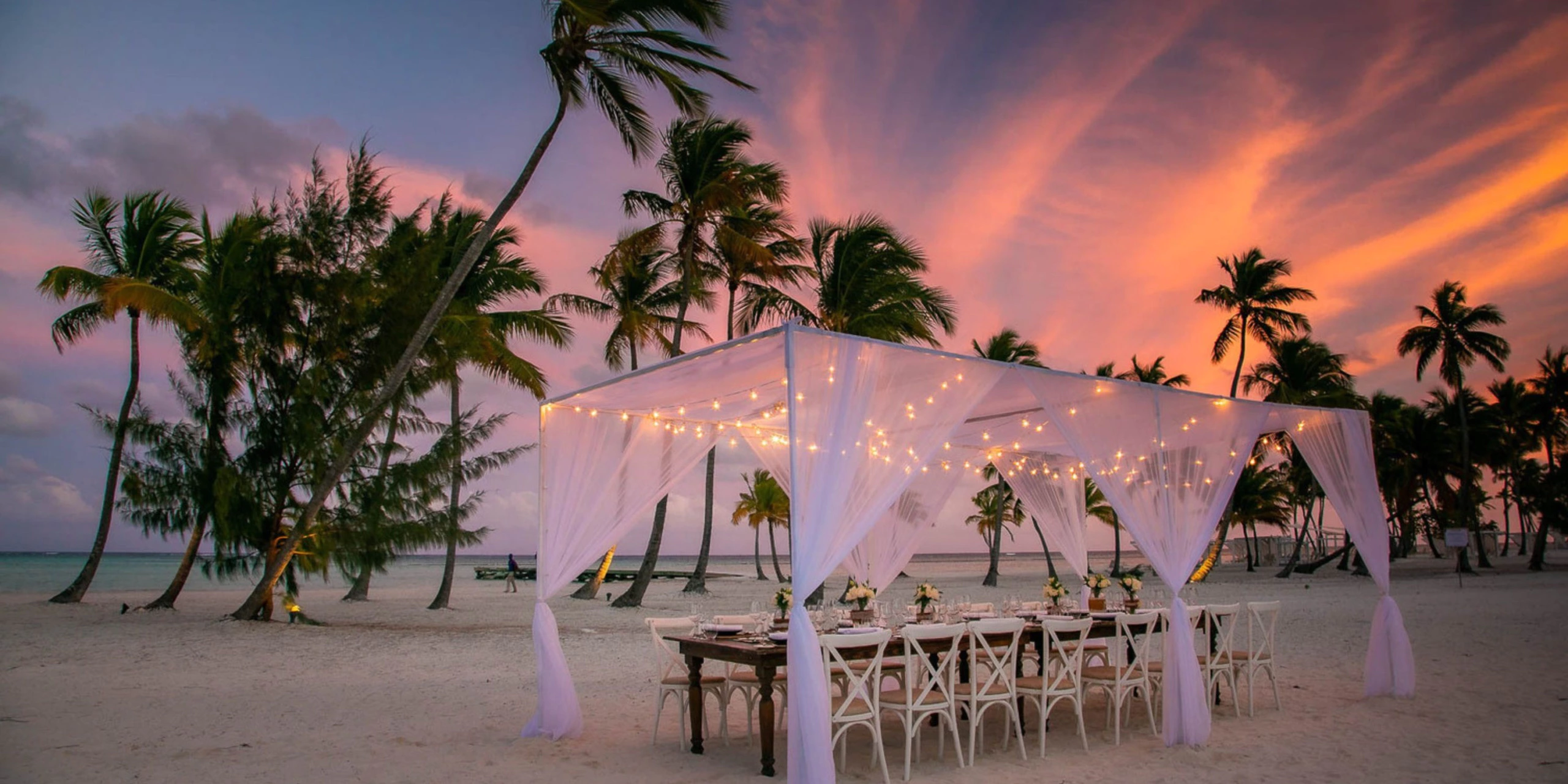 Private beachfront dinner setup beneath a canopy at sunset at Hyatt Zilara Cap Cana, perfect for romantic celebrations and special occasions.