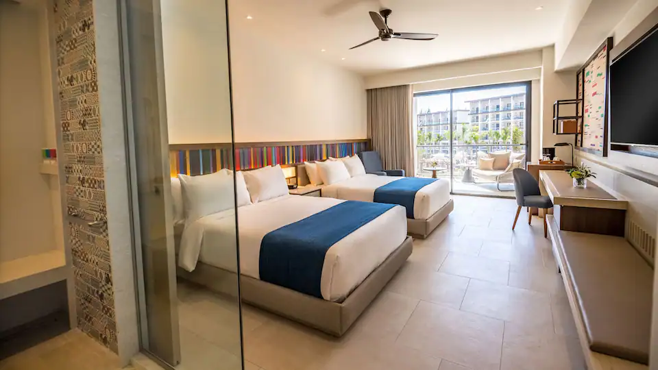 Junior Suite Double with two queen beds, sleeper sofa, and furnished balcony at Hyatt Zilara Cap Cana.
