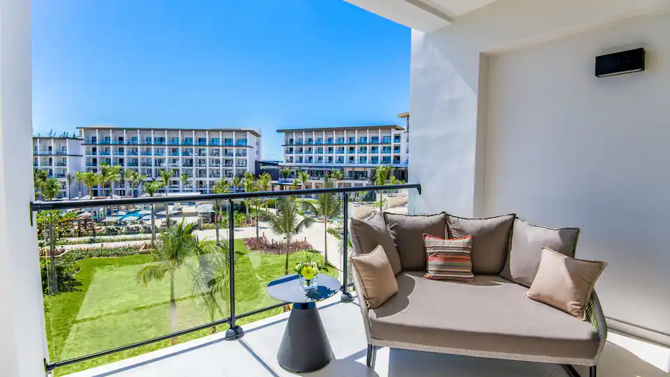Furnished balcony overlooking the resort grounds from the Junior Suite King at Hyatt Zilara Cap Cana.