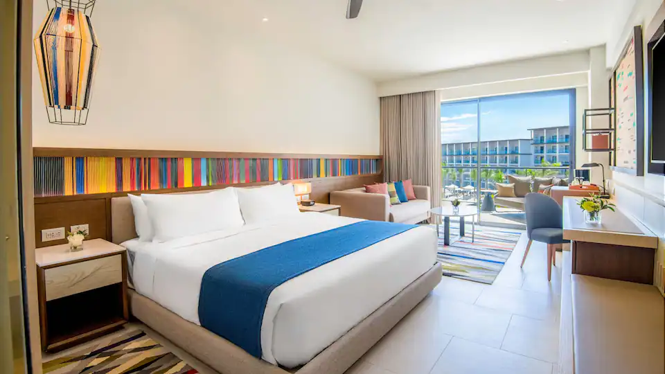 Junior Suite King with king bed, sleeper sofa, and furnished balcony at Hyatt Zilara Cap Cana.