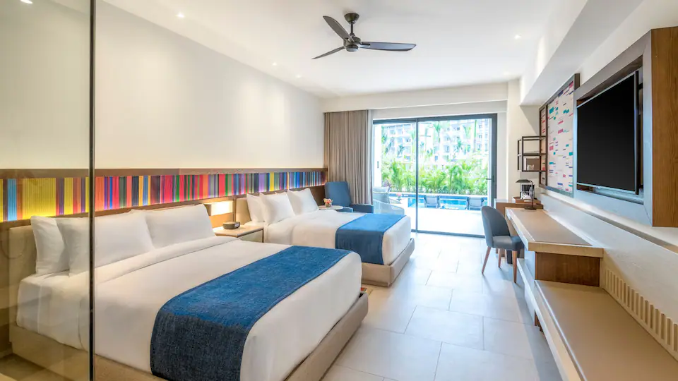 Junior Suite Swim-Up Double with two queen beds and direct pool access at Hyatt Zilara Cap Cana.