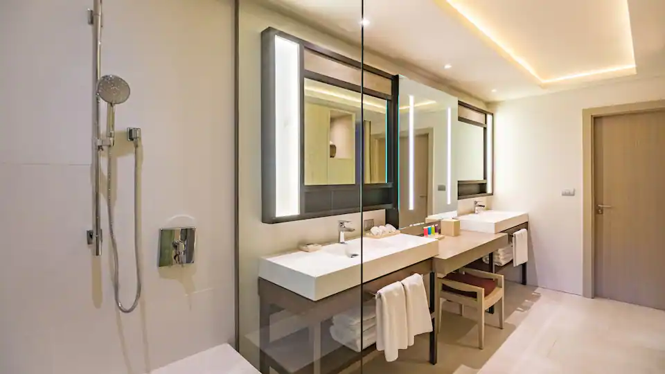 Junior Suite Swim-Up King bathroom with double vanity and separate shower at Hyatt Zilara Cap Cana.