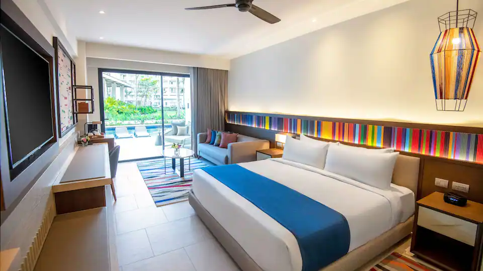 Junior Suite Swim-Up King bedroom with king bed and poolside terrace at Hyatt Zilara Cap Cana.