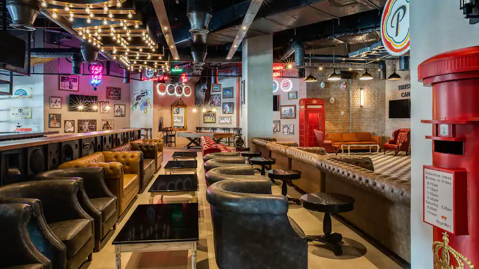 Moments sports lounge at Hyatt Zilara Cap Cana featuring comfortable seating, large-screen TVs, premium drinks, and a contemporary social atmosphere.