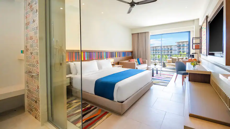 Resort View Junior Suite King with king bed, sleeper sofa, and private balcony at Hyatt Zilara Cap Cana.